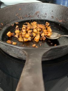 Front shot of a skillet with what's left of hash browned potatoes