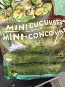 A closeup of a bag of Mucci mini cucumbers from Costco that have started to yellow and rot