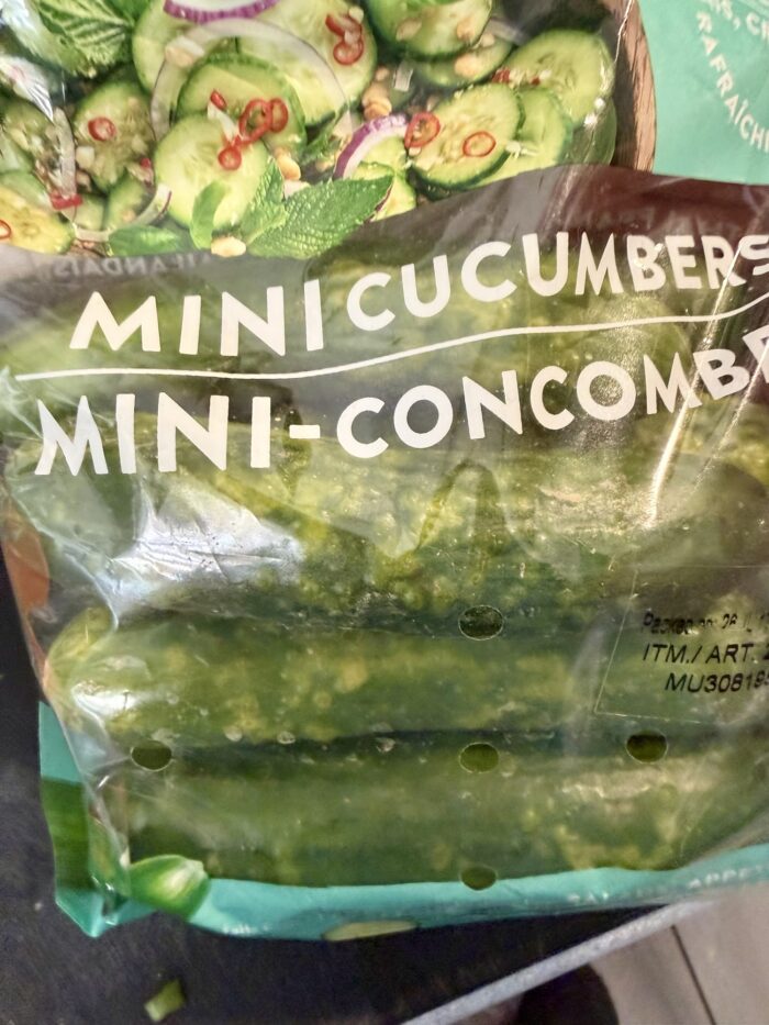 A closeup of a bag of Mucci mini cucumbers from Costco that have started to yellow and rot