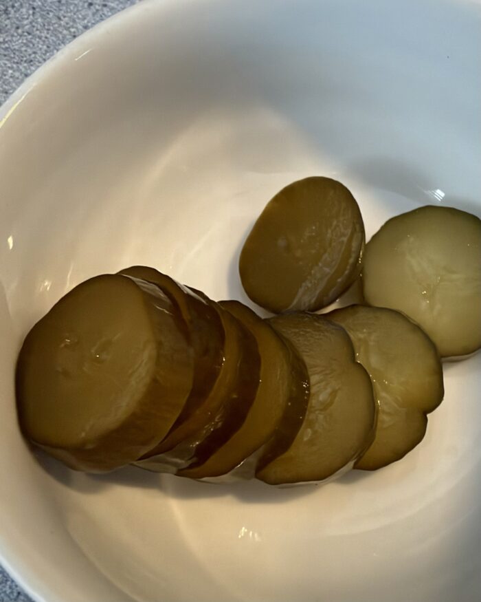 Sliced lacto-fermented pickles after two weeks in vinegar
