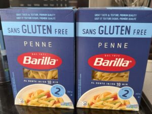 Two boxes of Barilla Gluten-Free Penne on a kitchen stove before testing.